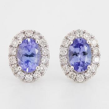 Oval faceted tanzanite and brilliant-cut diamond earrings.