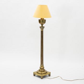 A brass floor lamp, circa 1900.