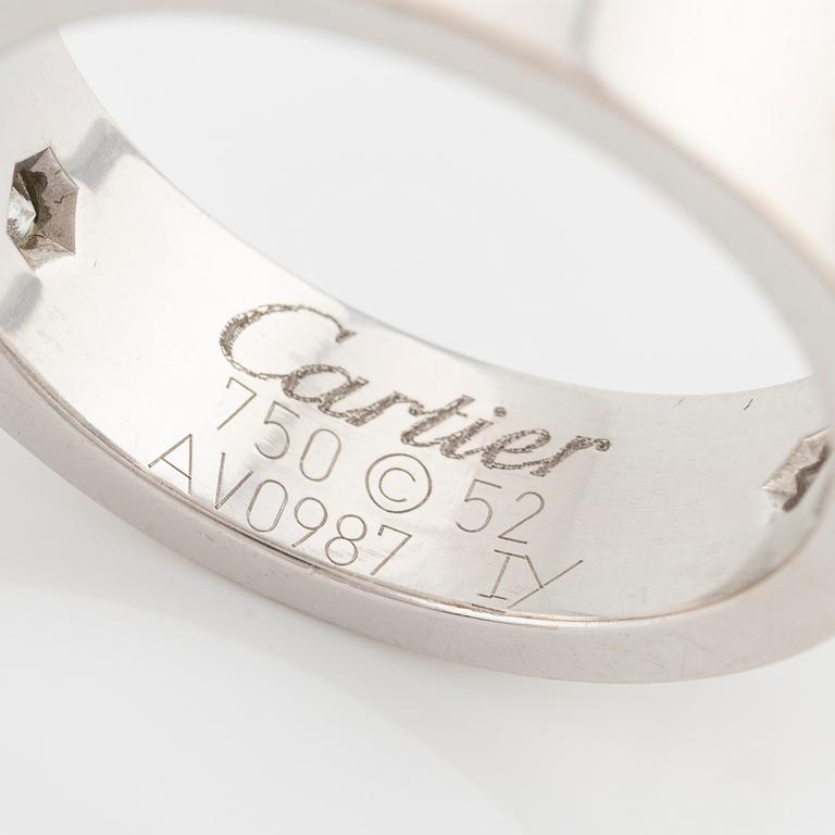 Cartier "Love" ring in 18K white gold with three round brilliant-cut diamonds.