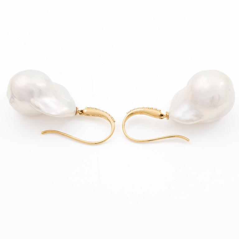 A pair of earrings with cultured baroque-shaped freshwater pearls and round brilliant-cut diamonds.
