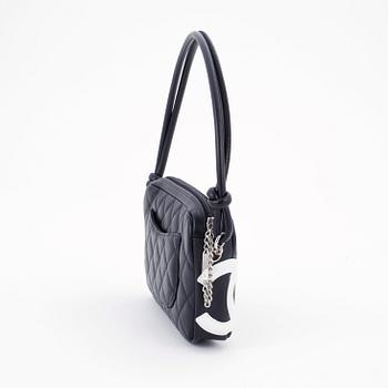 CHANEL, a black leather quilted pochette with short shoulder strap.