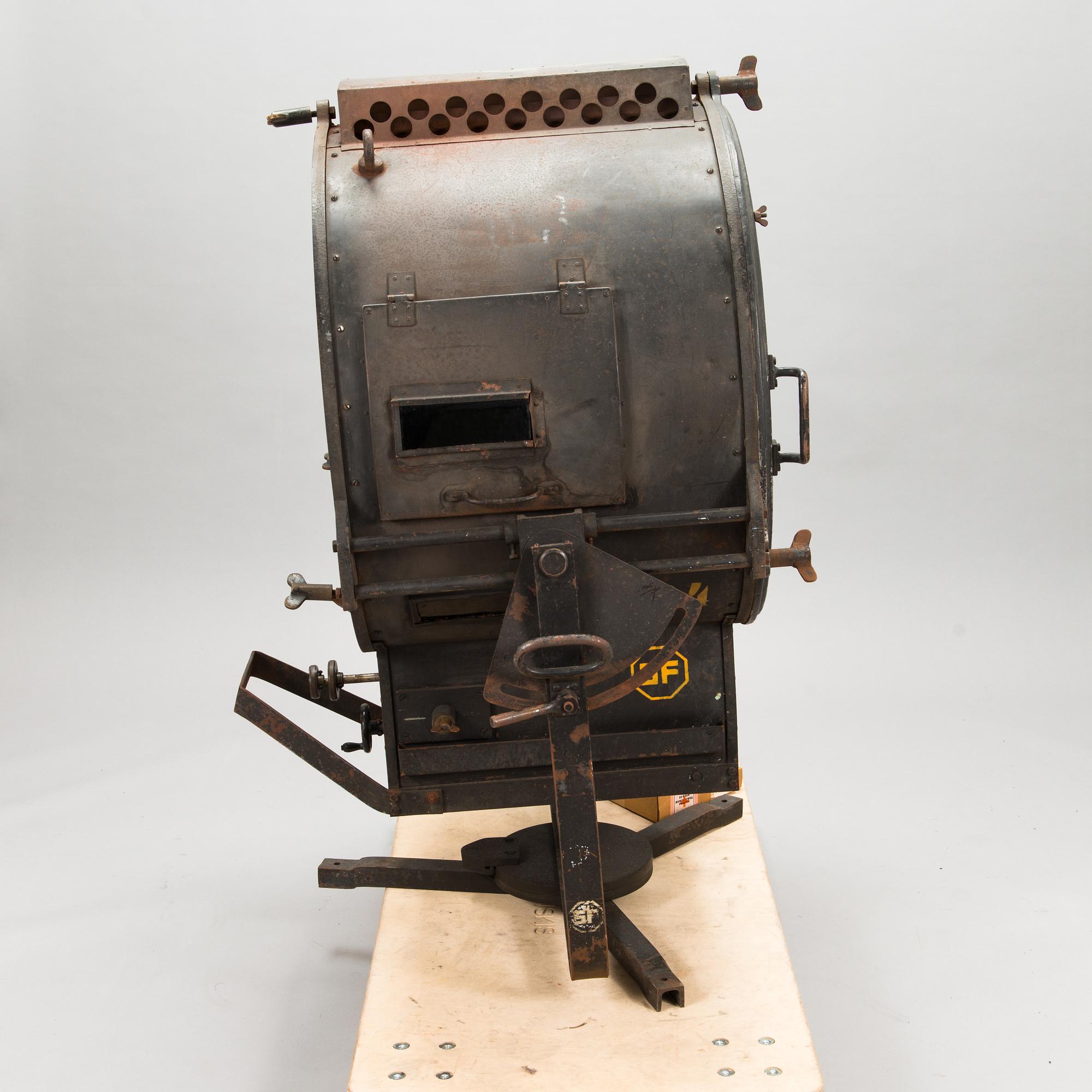 A film industry carbon arc spotlight with two boxes Kino-carbon sticks, + and -.