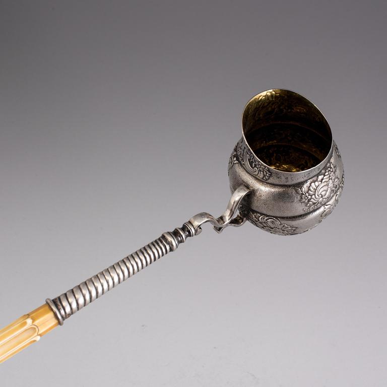 An 18th century parcel-gilt and bone ladle, unmarked.