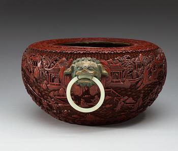 A large red lacquer censer/basin with bronze beast and nephrite ring handles, Qing dynasty, with Qianlong seal-mark.