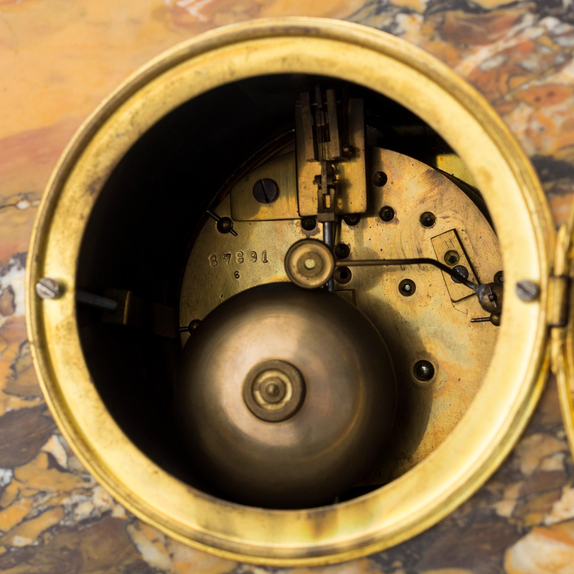 A turn of the century 1900 gilt brass and marble century mantle clock.