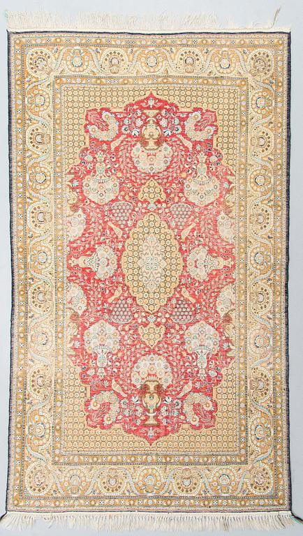 An oriental silk rug. Circa 188x106 cm.