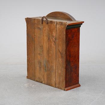 A Swedish provincial painted wall hanging cabinet, dated 1852.