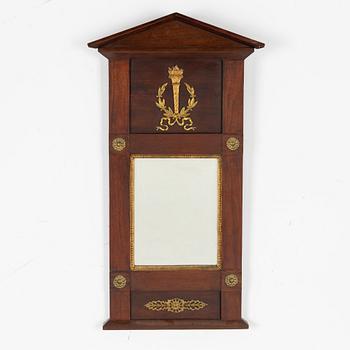 An Empire style mirror, circa 1900.