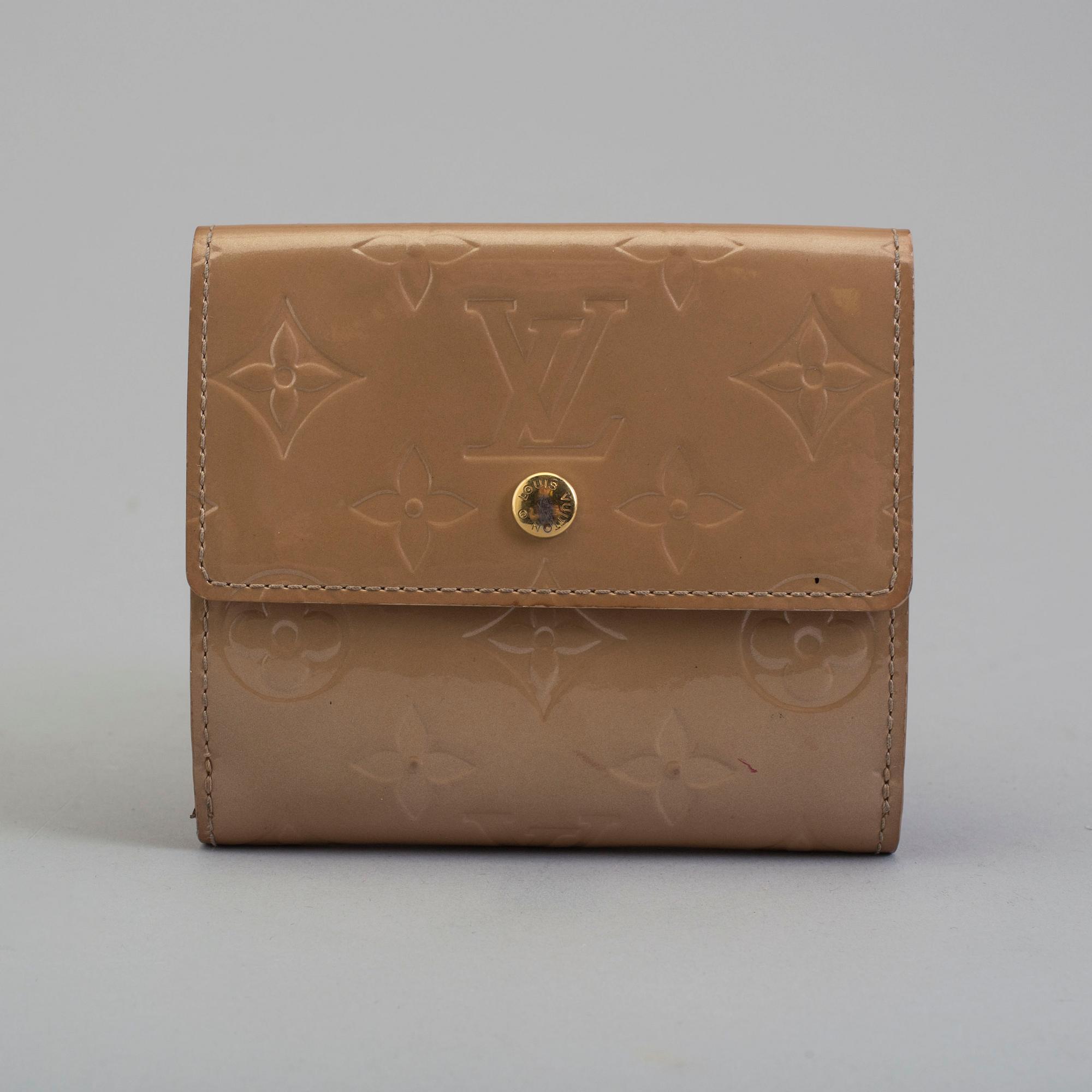 A beige monogram vernis wallet by Louis Vuitton.