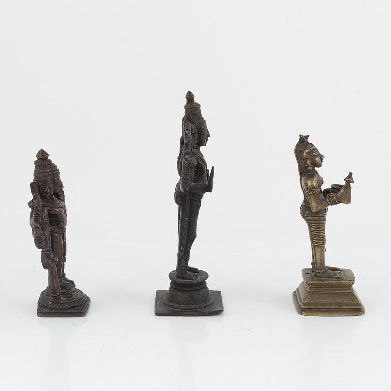 A group of three Indian bronze figures and an ewer, 20th century.
