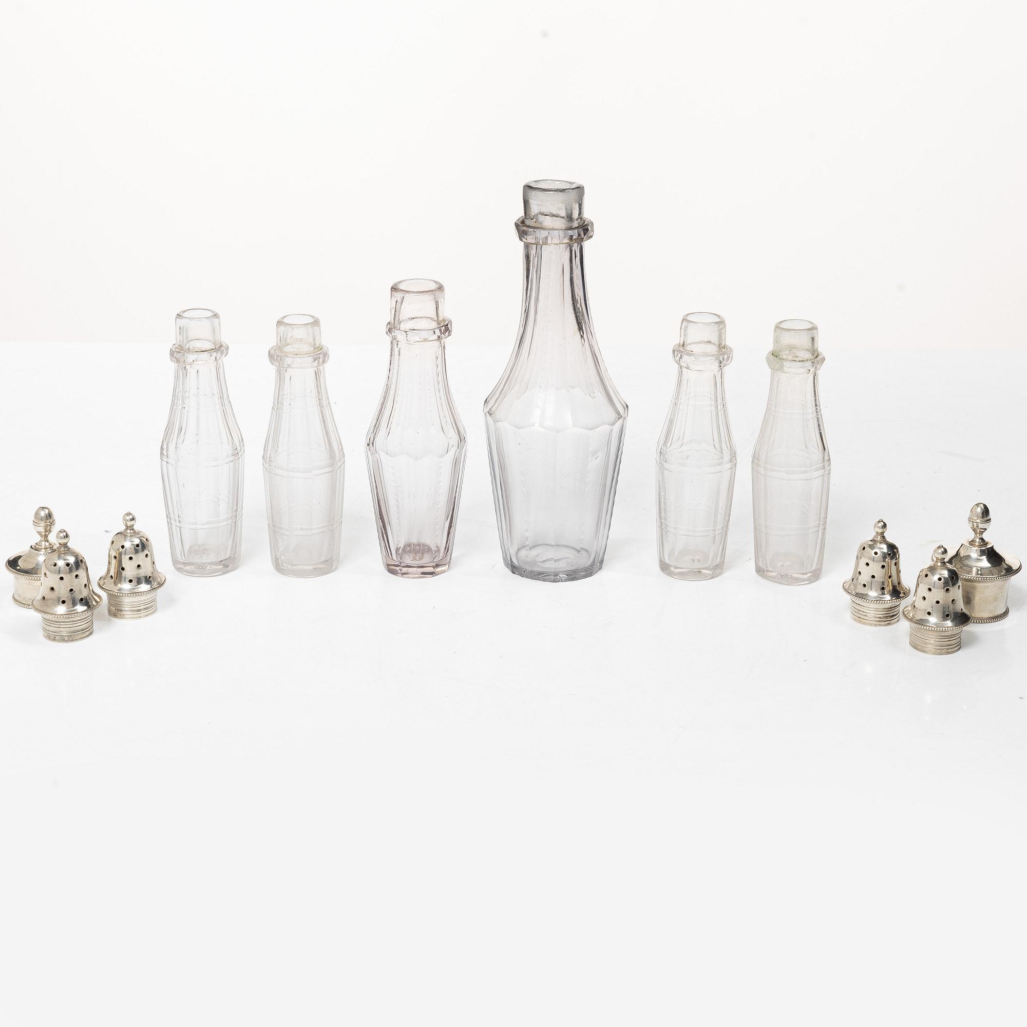 Parts for a table centrepiece, six glass bottles, and seven lids in silver, marked Pehr Zethelius, Stockholm 1807.