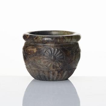 A well sculptured 'chrysanthemum' stone flowerpot, late Ming/early Qing dynasty.