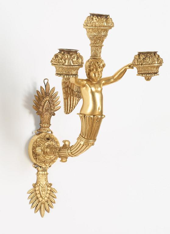 A pair of Empire early 19th century three-light wall-lights.