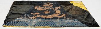 An embrodiered textile with a five clawed dragon, lined with yellow silk, Qing dynasty.