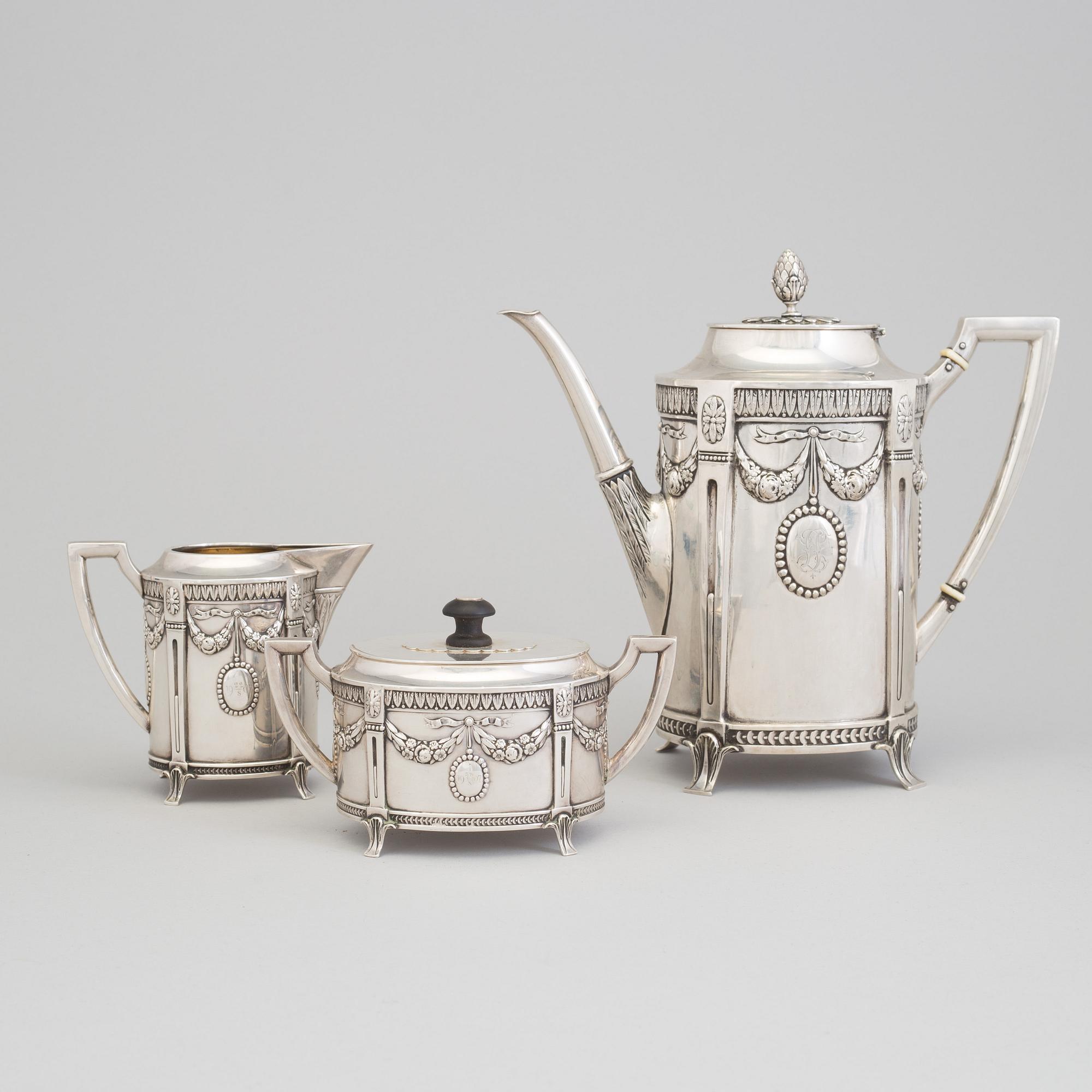 A set of three silver objects (coffeepot, creamer and sugarbowl, CG Hallberg and GAB, Stockholm 1907. Weight ca 1226 gr.