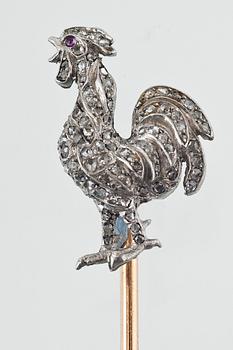 A ROOSTER PIN IN A FABERGÉ BOX.