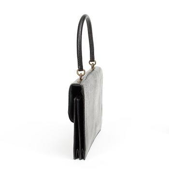 A black 1070s handbag by Hermès.