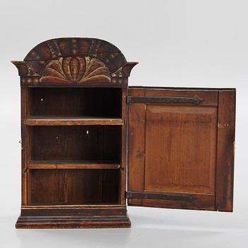 A painted cabinet, dated 1799.