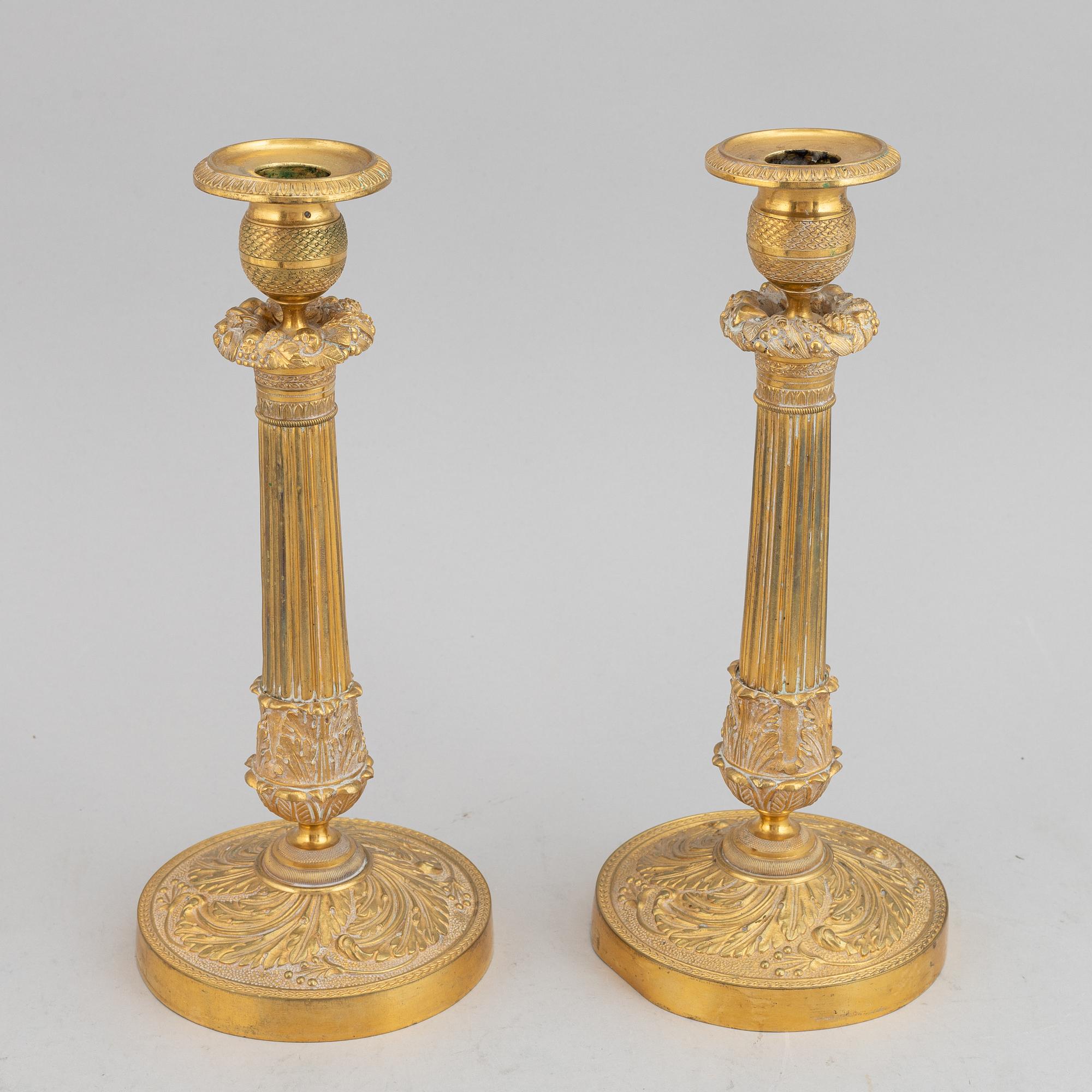 A circa 1900 empire style brass candlesticks.