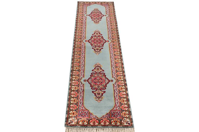 An oriental runner, c. 550 x 74 cm.