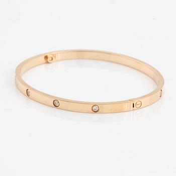 A Cartier "Love" bracelet small model in 18K rose gold with ten round brilliant-cut diamonds.