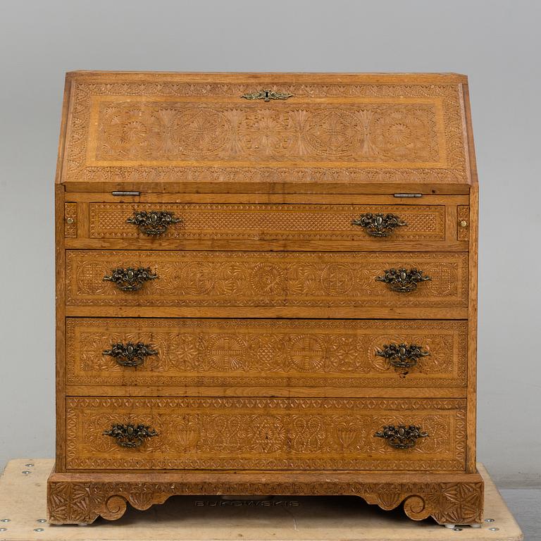 A carved oak secretaire, 19th Century.