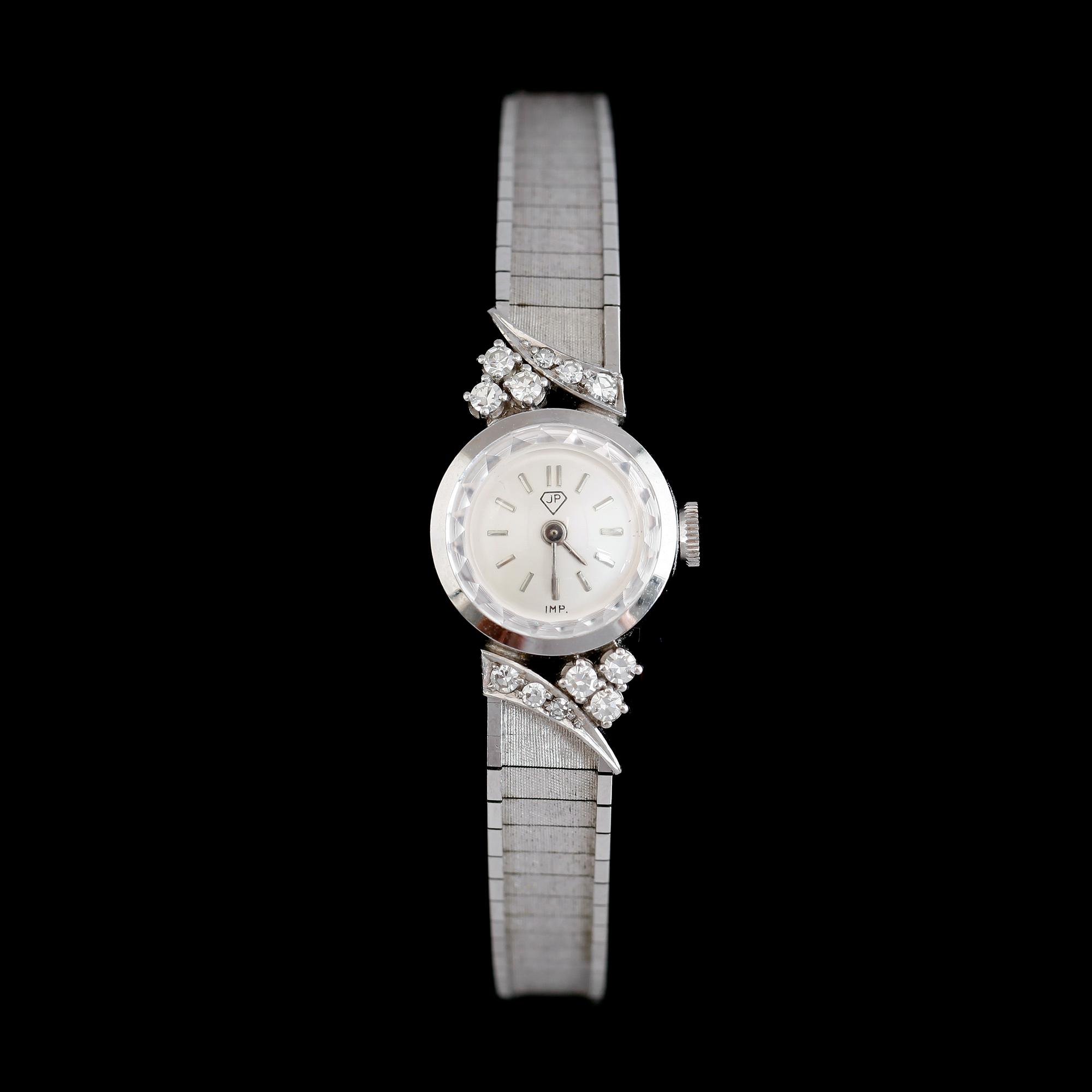 DAMARMBANDSUR, 18 k vitguld, briljantslipade diamanter tot ca 0.30 ct.