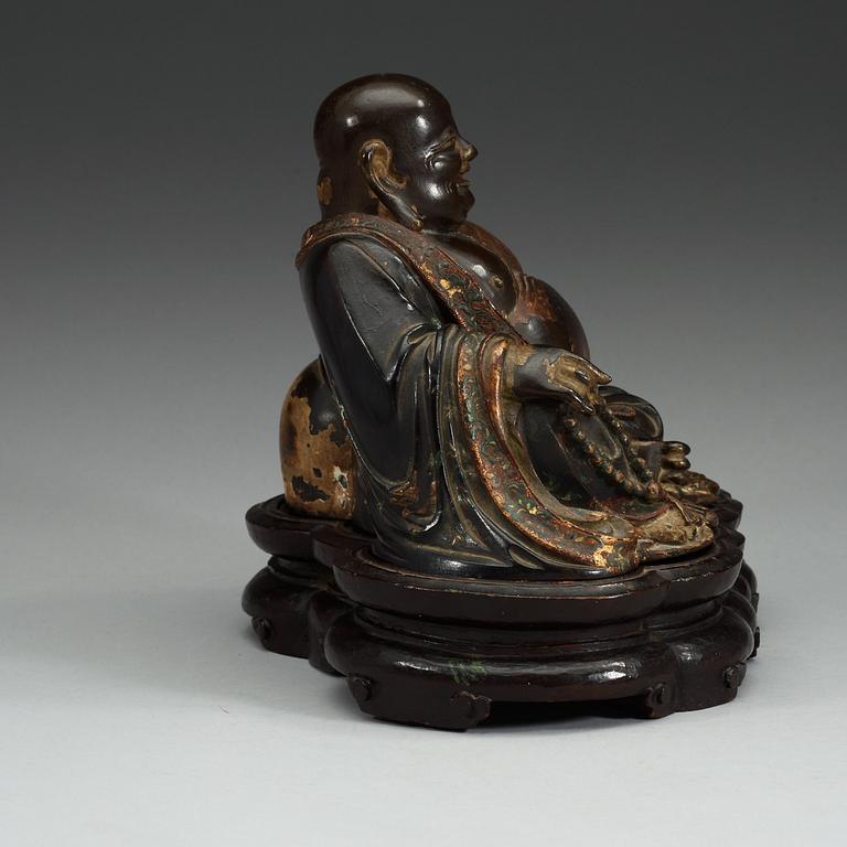 A lacquered bronze figure of Budai, Qing dynasty (1644-1912).