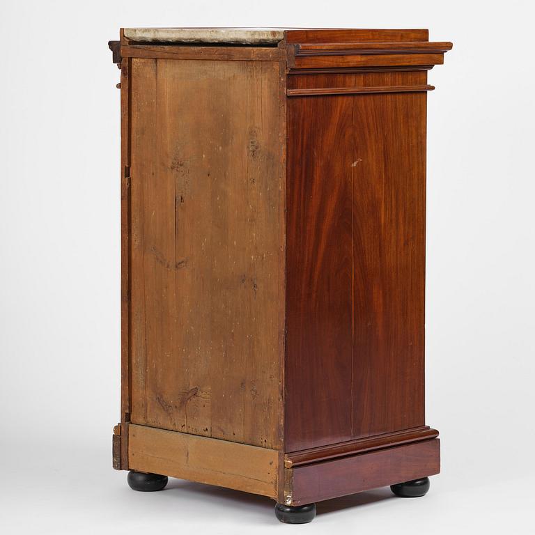 A late Gustavian mahogany column-cabinet, Stockholm, circa 1800.