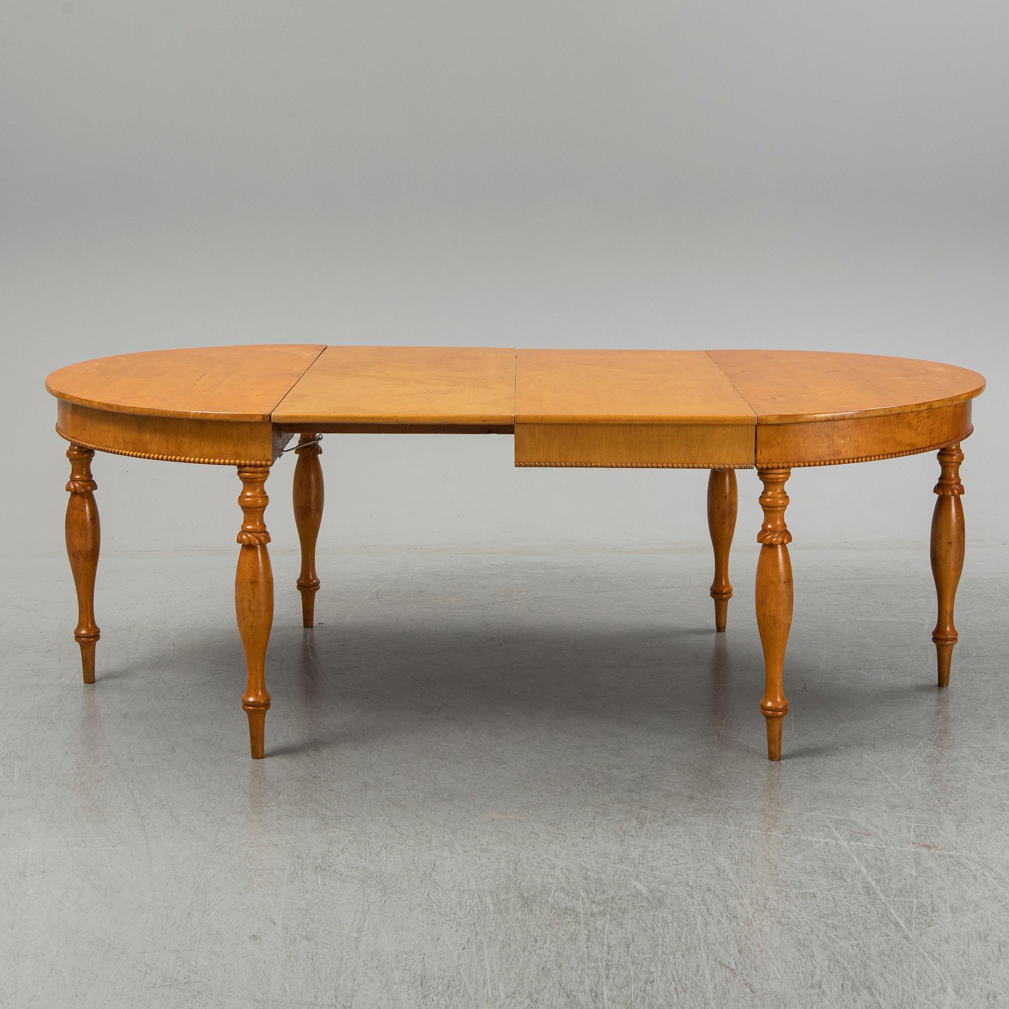 A mid 19th century birch dining table.