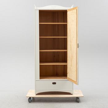 An early 20th Century painted clothes cabinet.