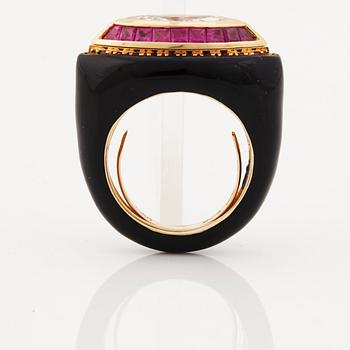 A ruby, diamond and black enamel ring.