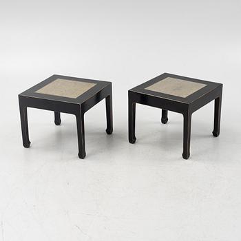 A pair of blac painted side tables with stone tops.