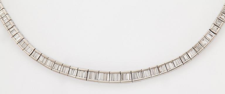 A platinum necklace set with tapered baguette-cut diamonds.