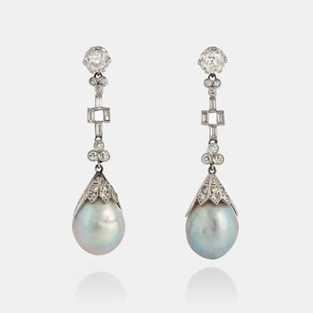 960. A pair of drop-formed pearl earrings in a box from Cartier.