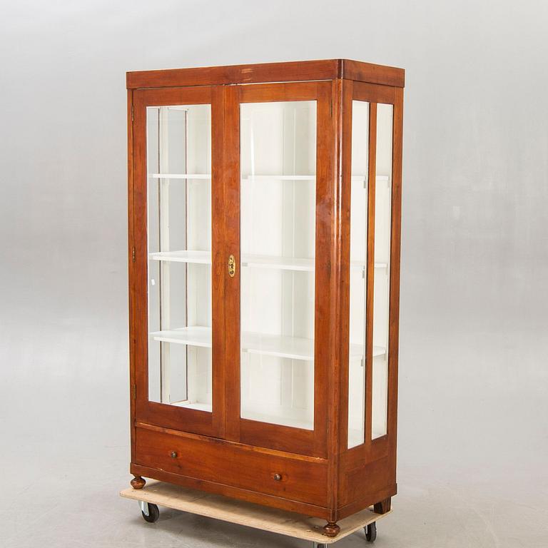 An early 1900s walnut display cabinet.