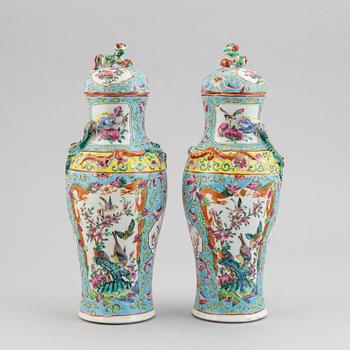 A pair of famille rose canton porcelain vases with covers, Qing dynasty, late 19th century.