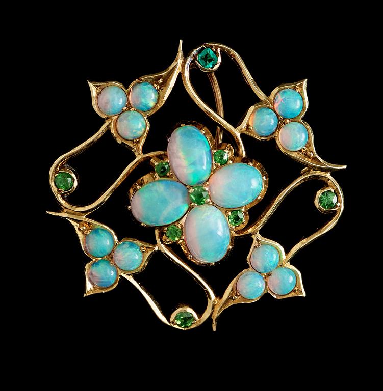 An arts and crafts opal and demantoid garnet brooch.