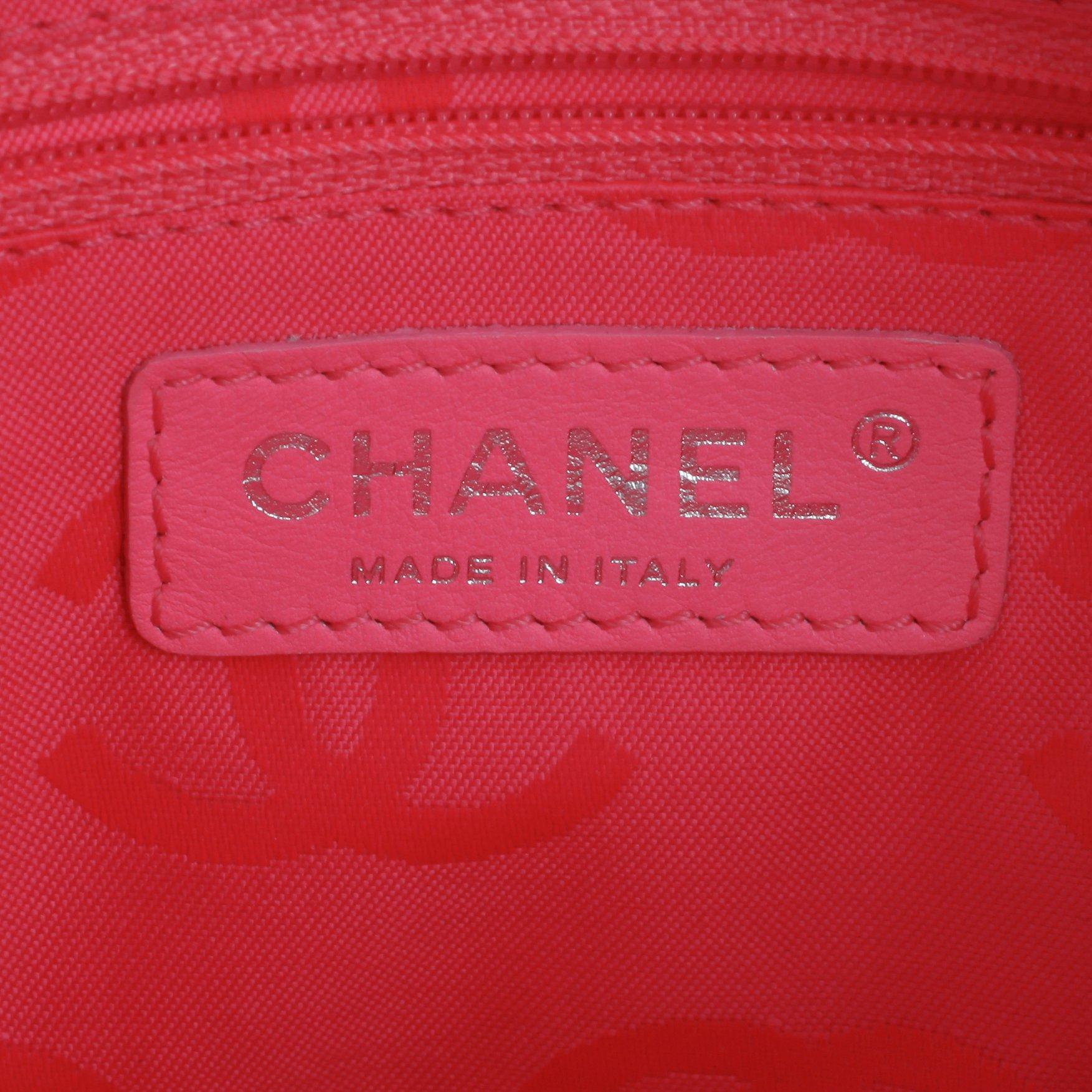 CHANEL, a black leather quilted pochette with short shoulder strap.