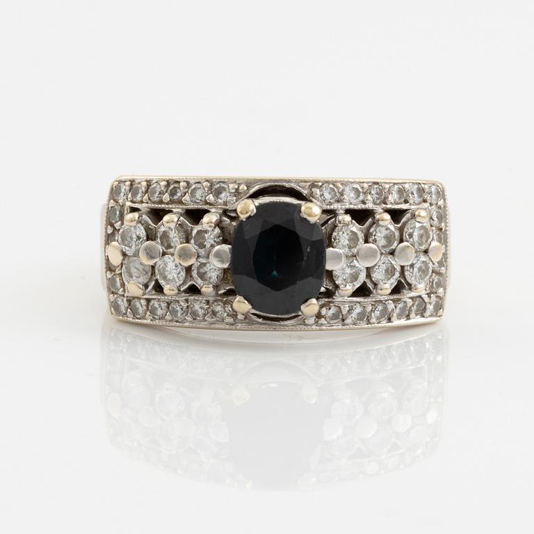 Ring with dark sapphire and brilliant-cut diamonds.