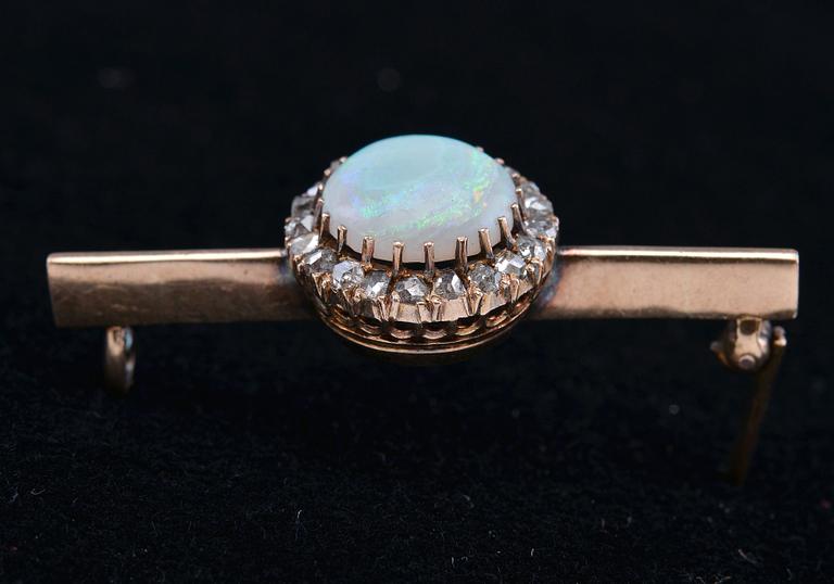 A BROOCH, opal c. 2.5 ct, rose cut diamonds c. 0.2 ct. C.G. Hallberg Stockholm 1875. Weight 5 g.