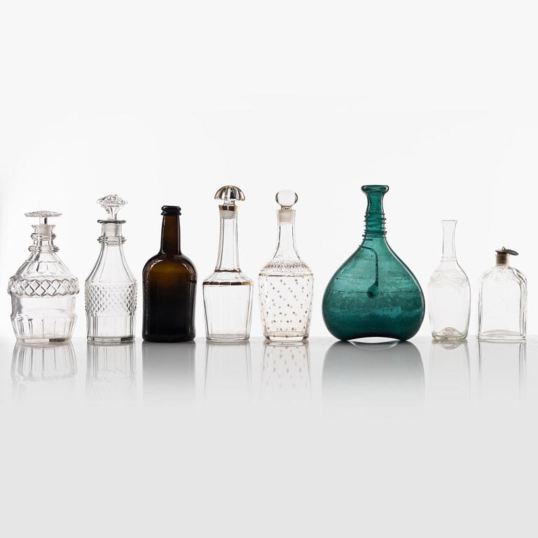 A set of eight glass bottles and decanters, circa 1800/19th Century.
