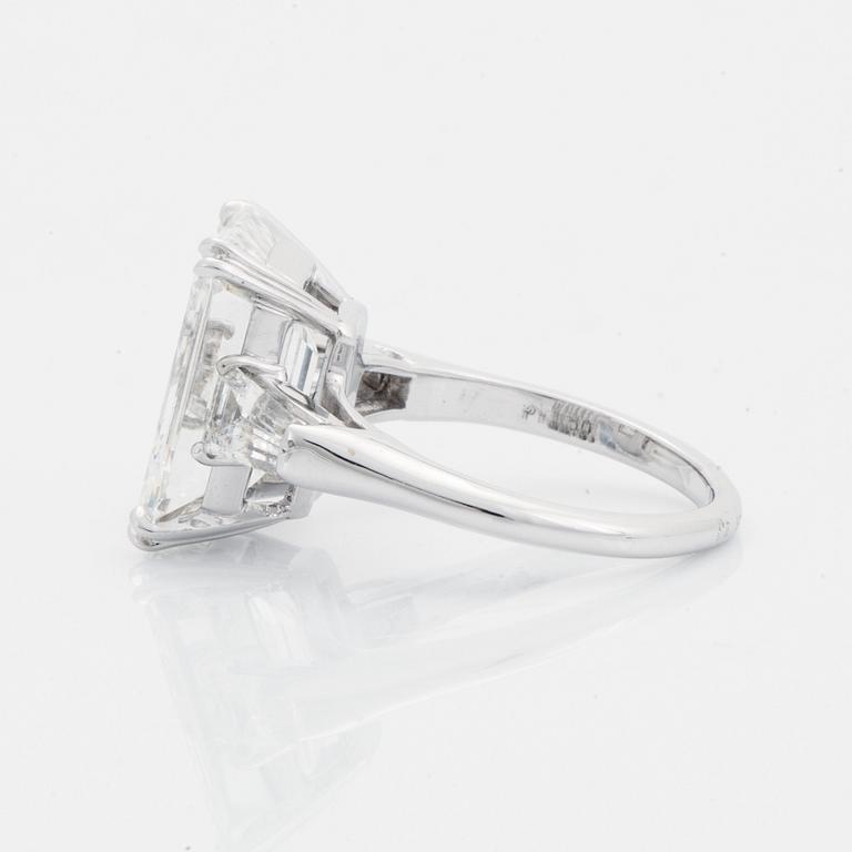 A platinum ring set with an emerald-cut diamond.