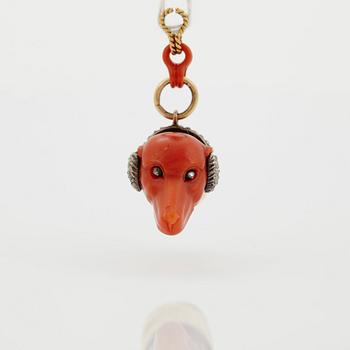 A 14 K gold and silver pendant with carved coral set with rose-cut diamonds.