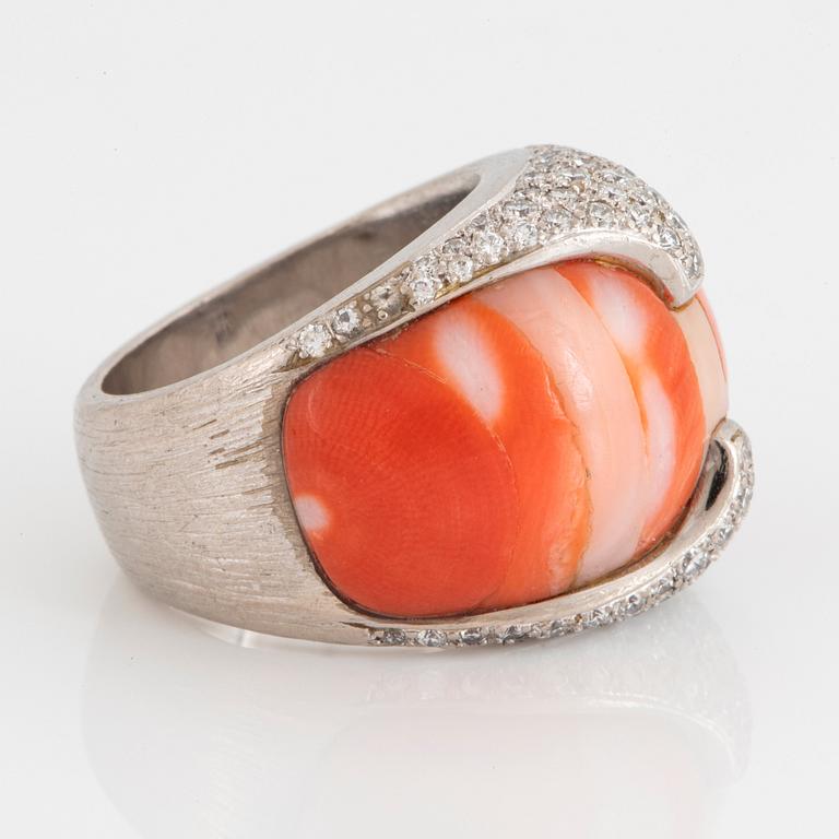 A Paul Binder ring in 18K white gold set with coral and round brillliant-cut diamonds.