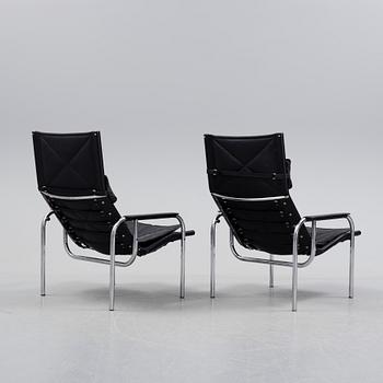 A pair of easy chairs and ottoman, designed by Hans Eichenberger, Strässle, Switzerland.