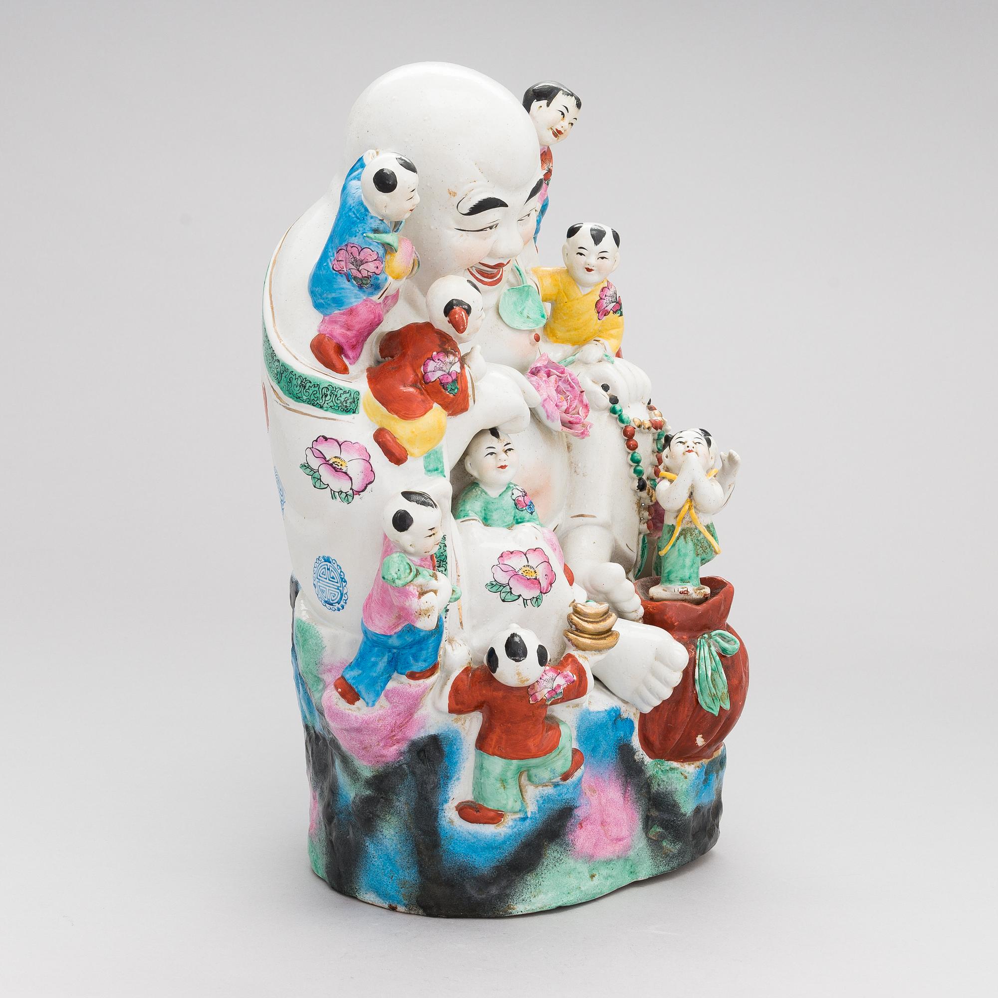 A Chinese porcelain laughing buddha with children, the 20th century.