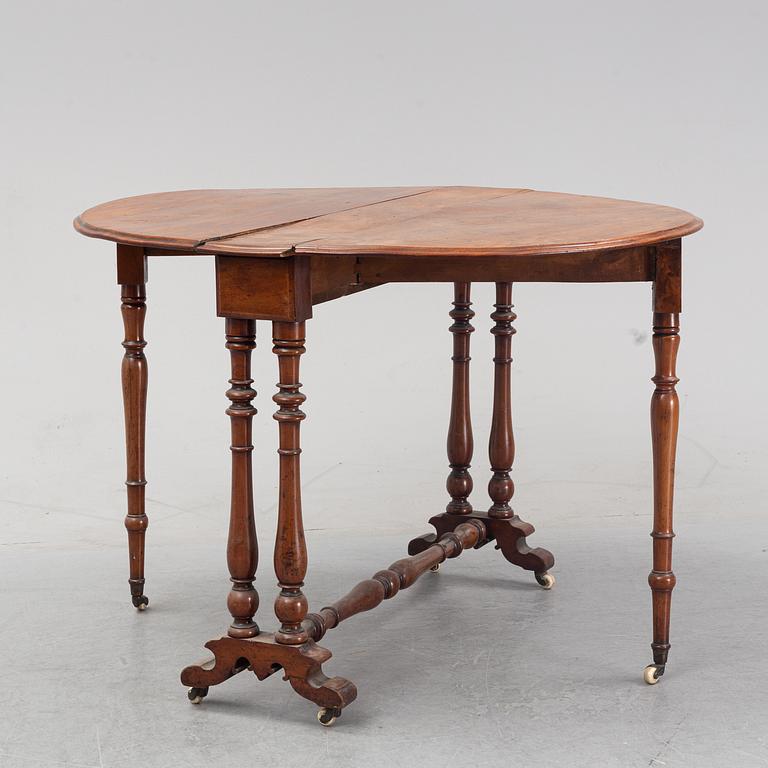 A neo-renaissance mahogany drop-leaf table from secord half of 19th century.