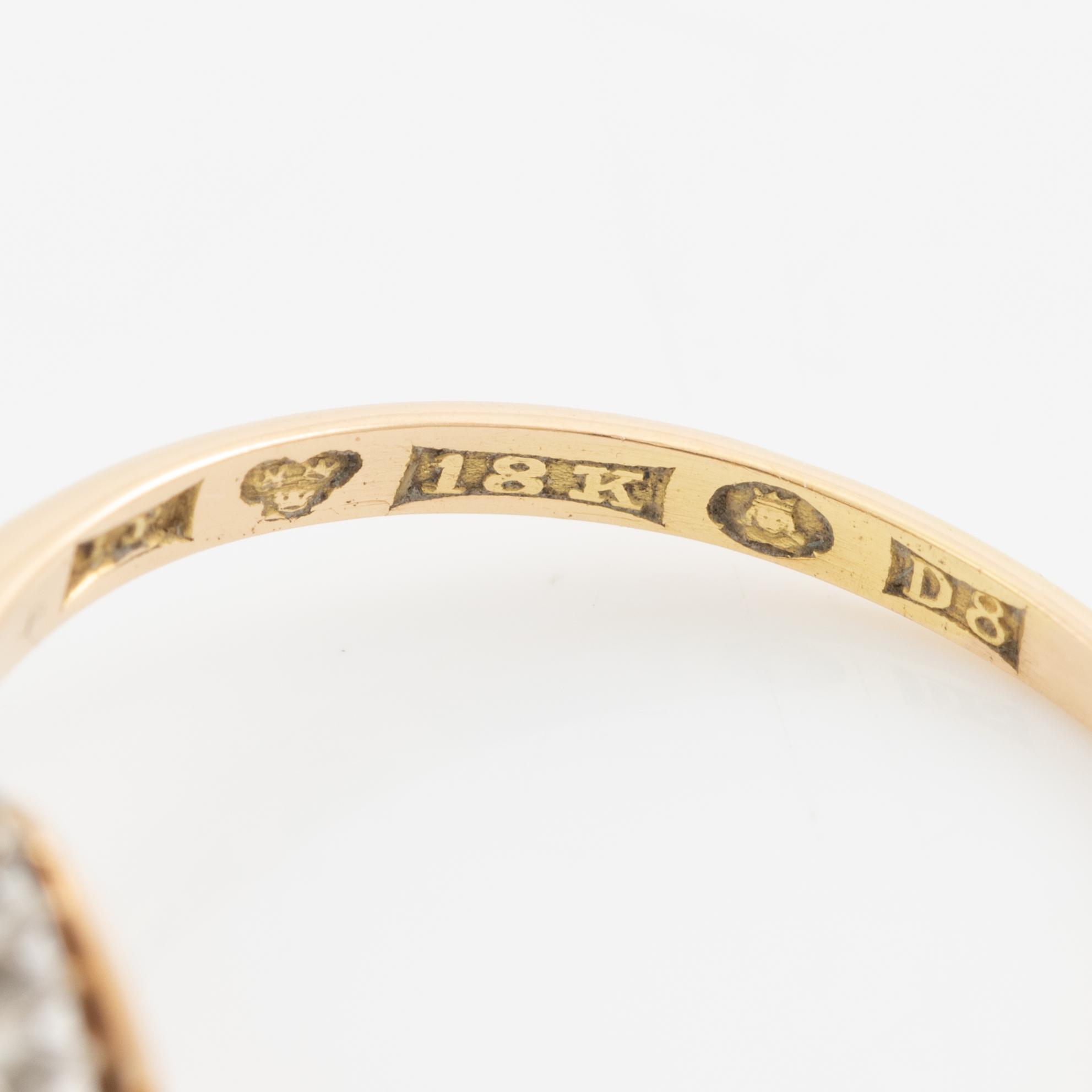 Ring in 18K gold set with a faceted synthetic ruby and eight-cut diamonds.