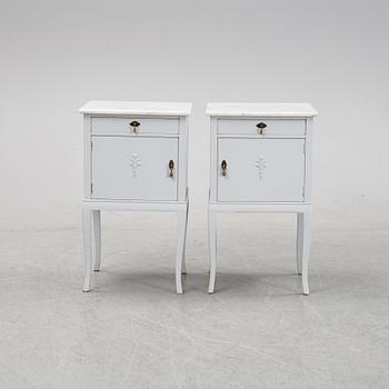 A pair of painted bedside tables with marble tops, 1920's.